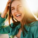 Woman with long hair smiling in sun